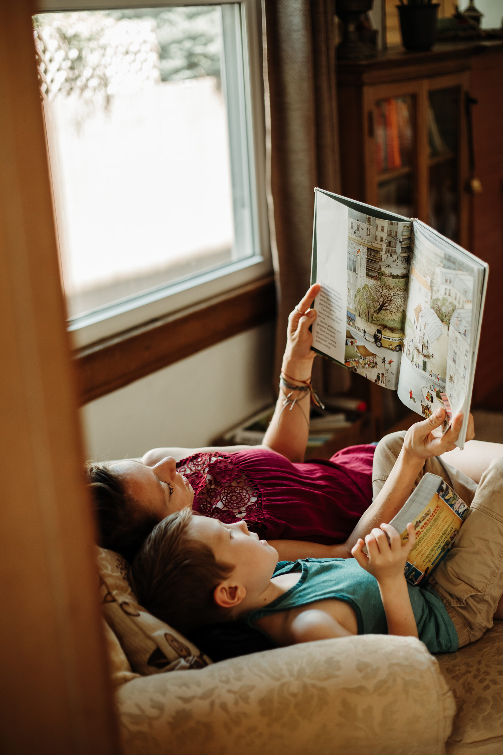 mother reading to son on couch in their living room in denver