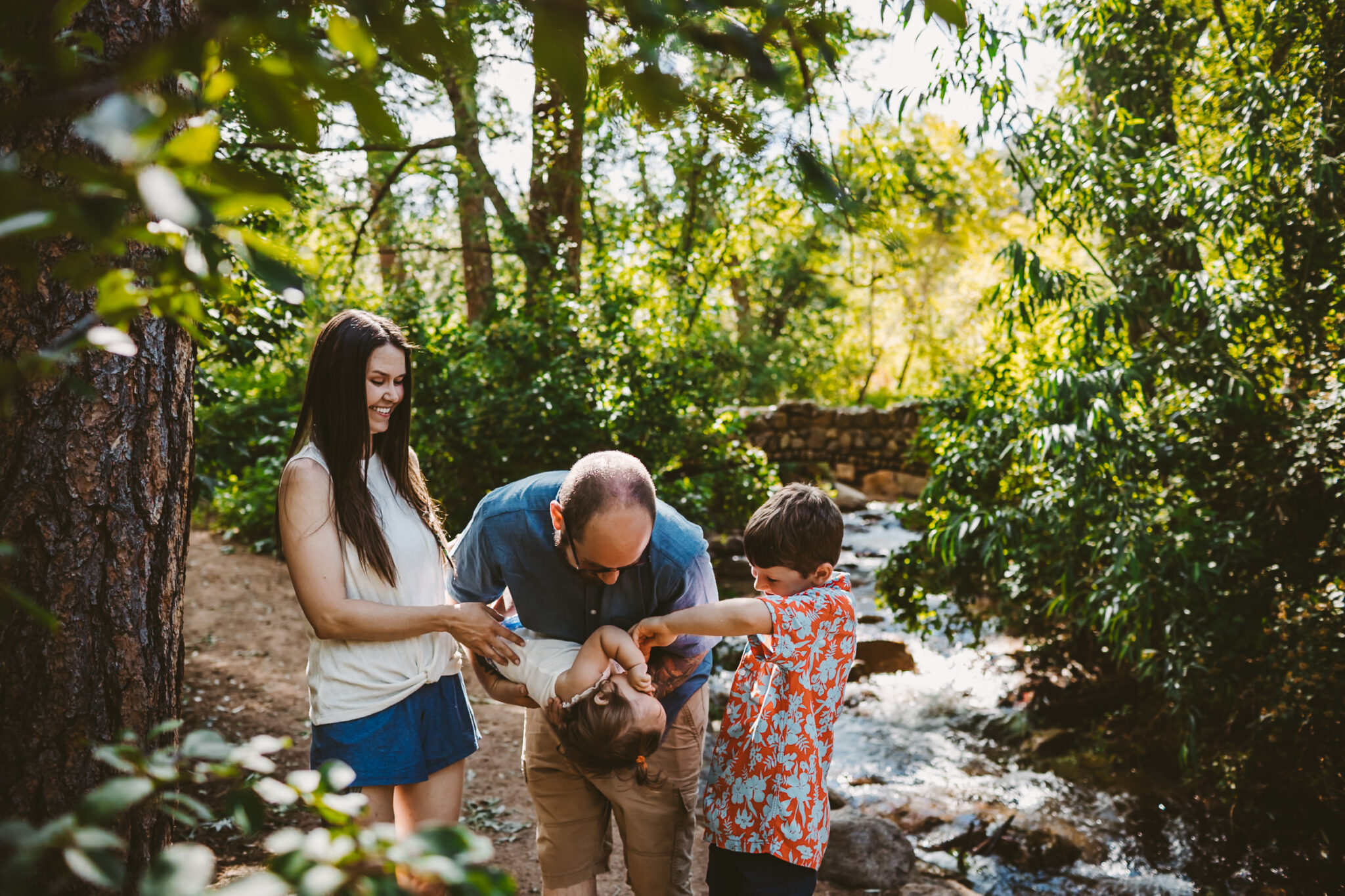 playful family photos near creek at cheyenne canyon