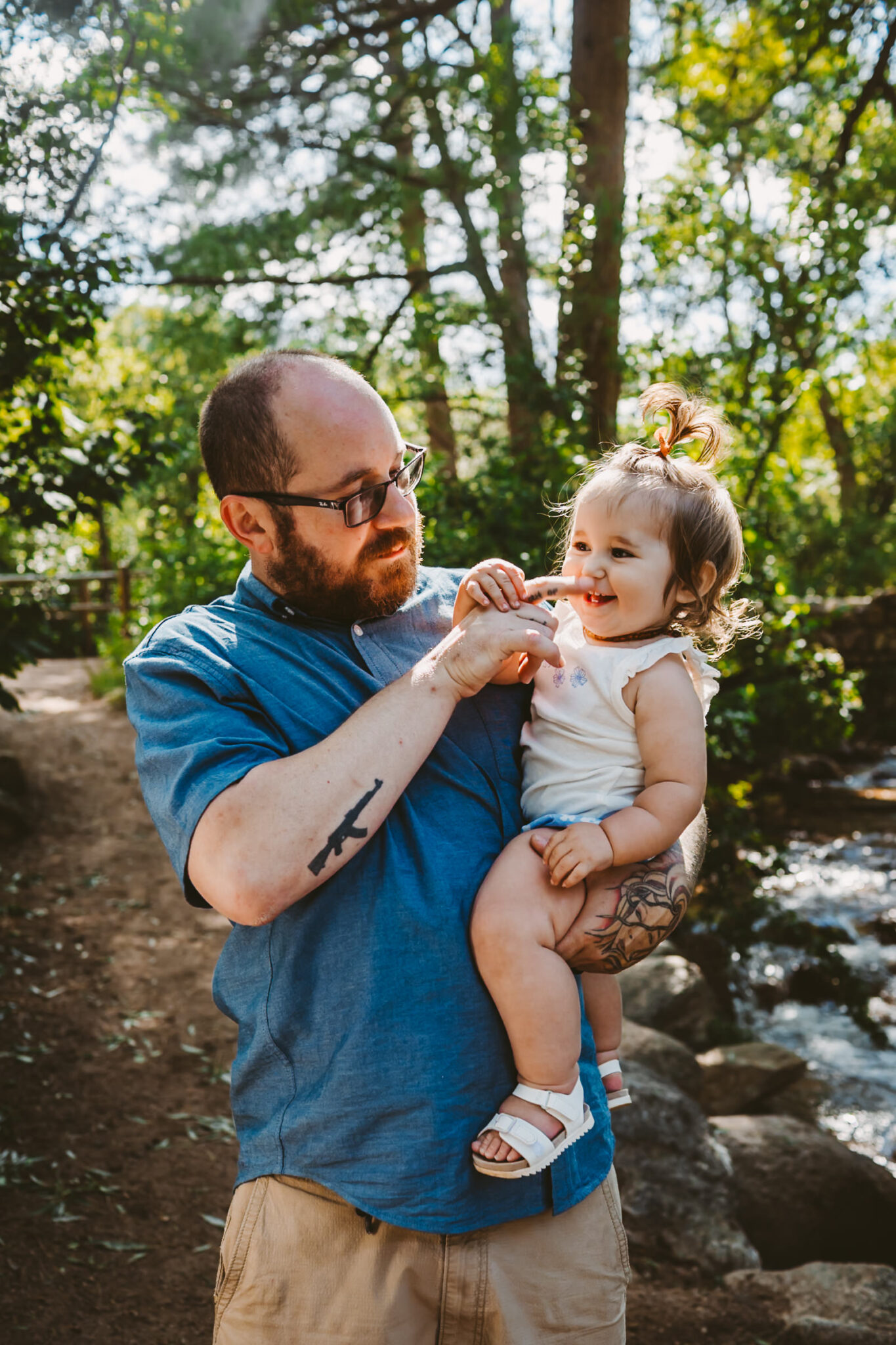 father plays with daughter in colorado mountains
