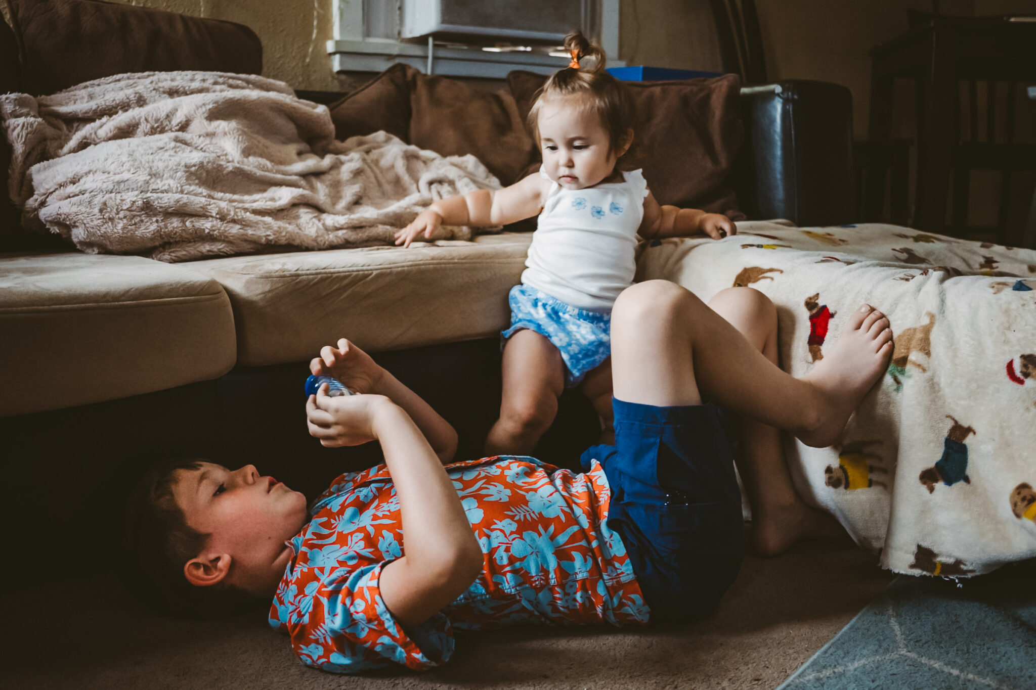 young boy and sister playing in living room in downtown colorado springs home