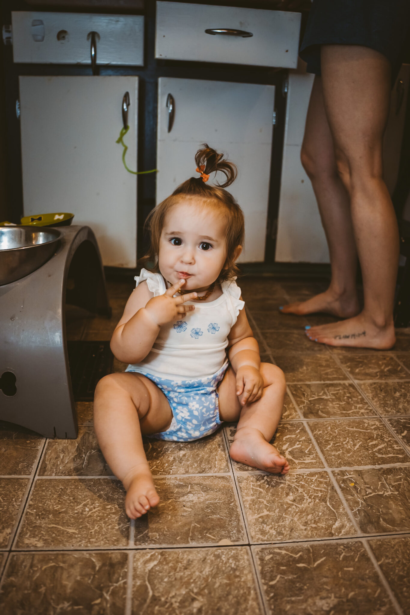 young girl playing with dog food bowls