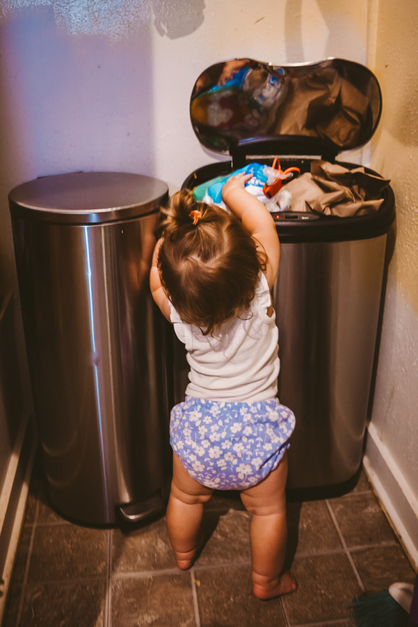 toddler puts marshmellos in trash can